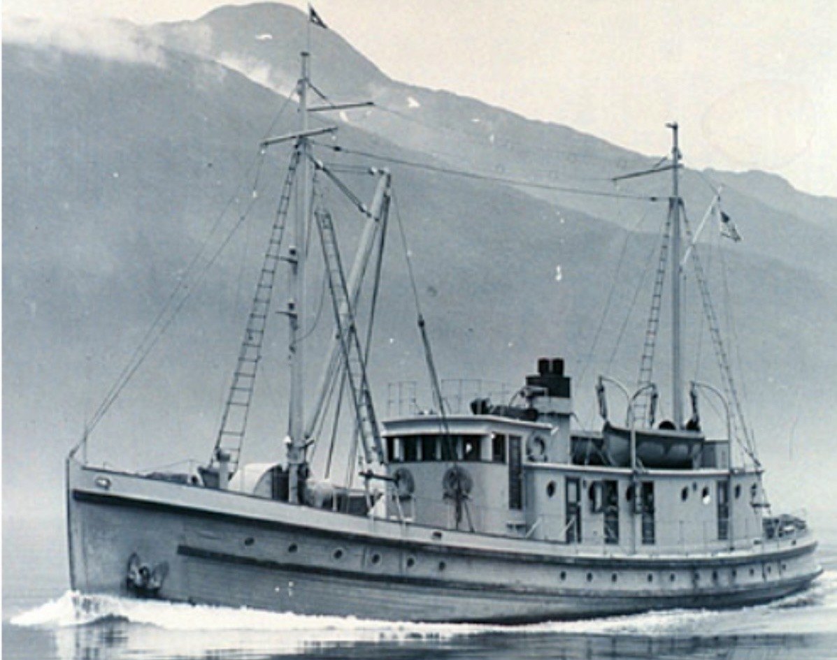 Crane underway in Gastineau Channel, Juneau, early 1930s, mountains behind
