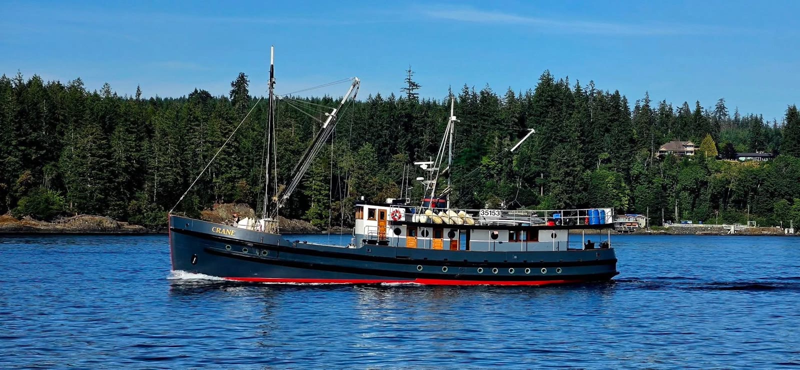 Crane underway, gold name on the bow, red bottom, wooden cabin, number 35153